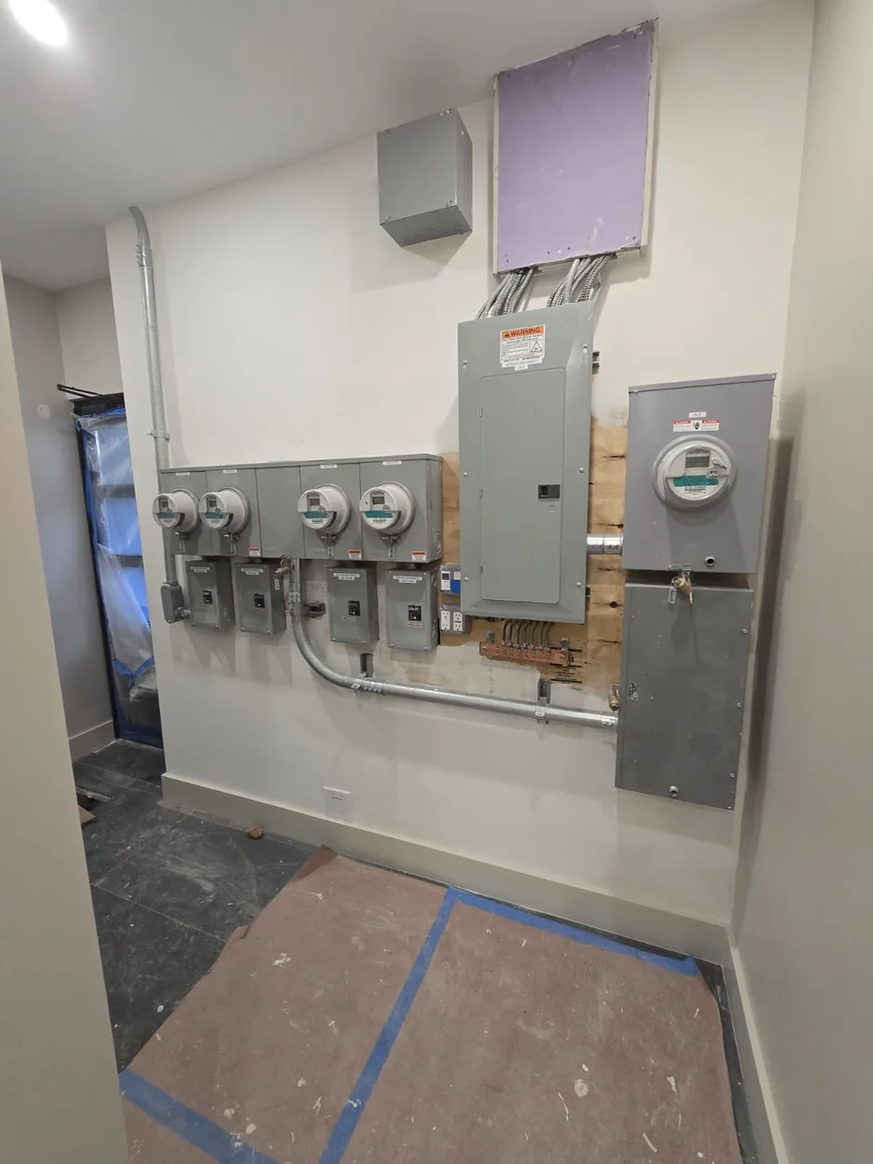 Electrical panels and meter equipment installed along a building wall