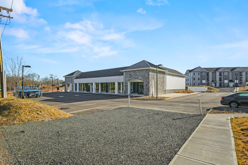 Oak Tree Plaza storefront, parking area and pole lights at 540 Route 34