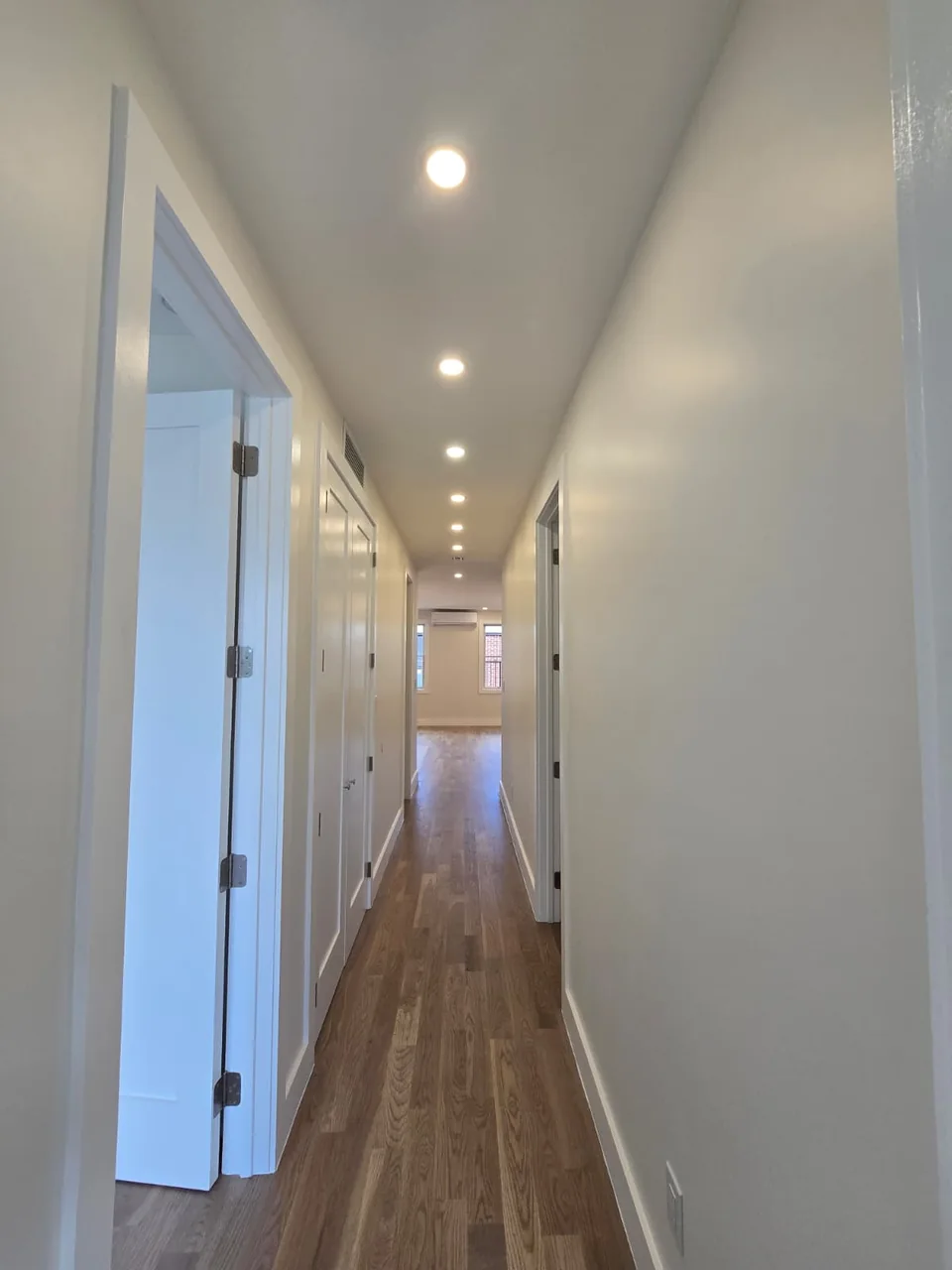 Recessed ceiling lighting along a residential hallway